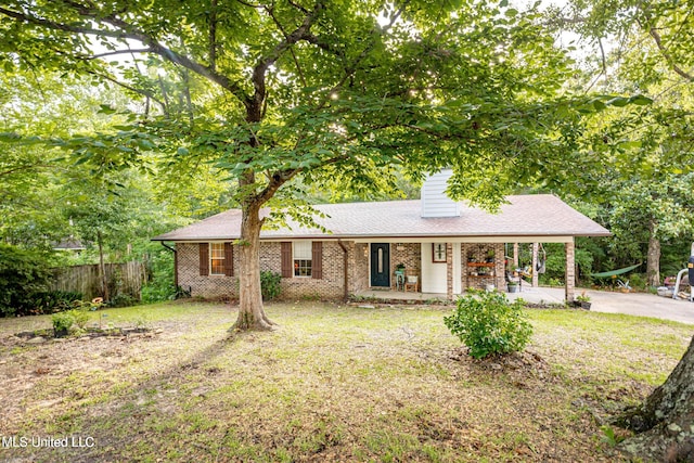 view of front facade with a front yard and a patio