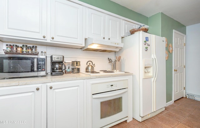 kitchen featuring white cabinets, decorative backsplash, and white appliances