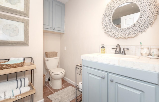 bathroom featuring tile patterned floors, vanity, and toilet