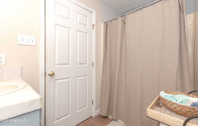 bathroom with tile patterned flooring and vanity