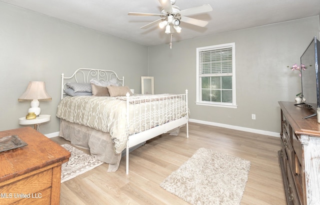 bedroom with light hardwood / wood-style floors and ceiling fan