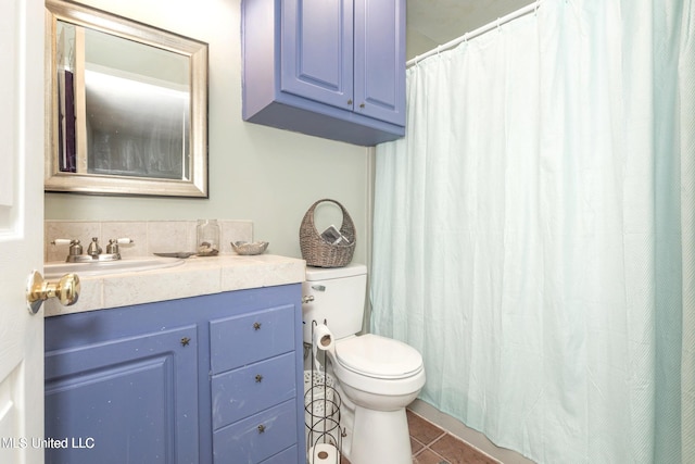 bathroom featuring tile patterned floors, vanity, and toilet