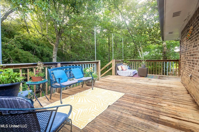 wooden deck featuring an outdoor hangout area