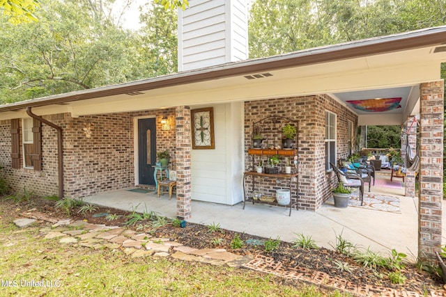 doorway to property featuring covered porch