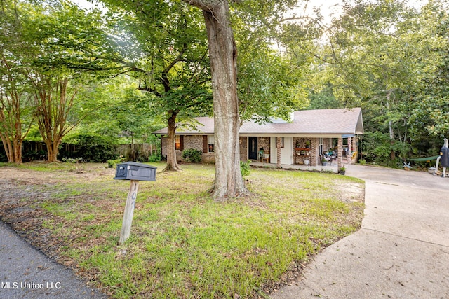 ranch-style house with a porch and a front lawn