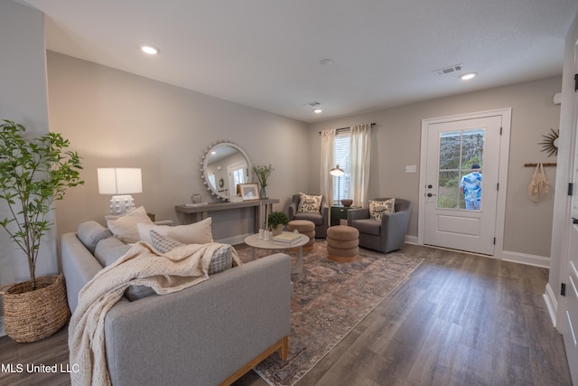 living room with dark hardwood / wood-style flooring