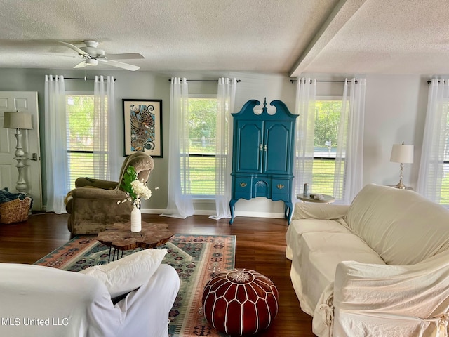 3620 Cochran Ave, Moss Point, MS 39562 - living room featuring a textured ceiling, ceiling fan, dark wood-style floors, and baseboards