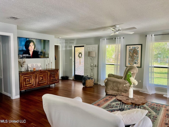 3620 Cochran Ave, Moss Point, MS 39562 - living room with a textured ceiling, wood finished floors, a ceiling fan, and baseboards