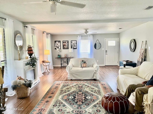 3620 Cochran Ave, Moss Point, MS 39562 - living room with a ceiling fan, wood finished floors, a textured ceiling, and baseboards