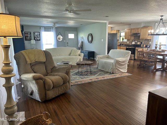 3620 Cochran Ave, Moss Point, MS 39562 - living area featuring a ceiling fan, dark wood finished floors, a textured ceiling, and a chandelier