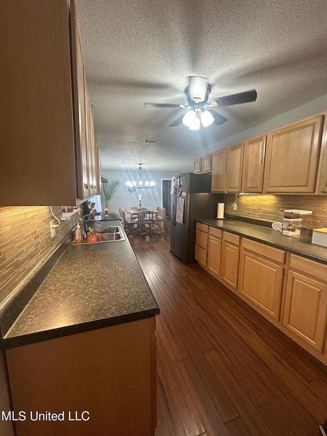 3620 Cochran Ave, Moss Point, MS 39562 - kitchen with a sink, a ceiling fan, dark countertops, freestanding refrigerator, and dark wood finished floors