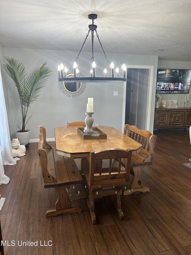 3620 Cochran Ave, Moss Point, MS 39562 - dining area with a chandelier, wood finished floors, and a textured ceiling