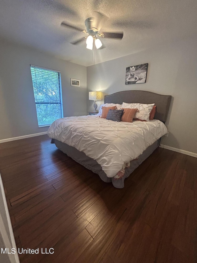 3620 Cochran Ave, Moss Point, MS 39562 - bedroom with wood finished floors, a textured ceiling, baseboards, and ceiling fan