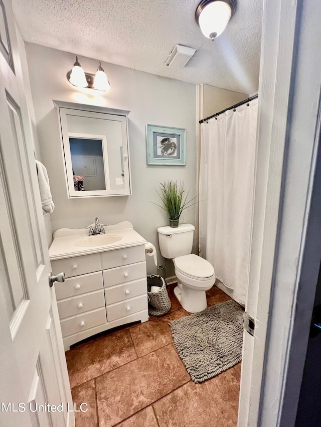 3620 Cochran Ave, Moss Point, MS 39562 - bathroom featuring vanity, toilet, a textured ceiling, curtained shower, and tile patterned flooring