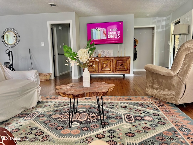 3620 Cochran Ave, Moss Point, MS 39562 - living room featuring wood finished floors, a textured ceiling, and baseboards