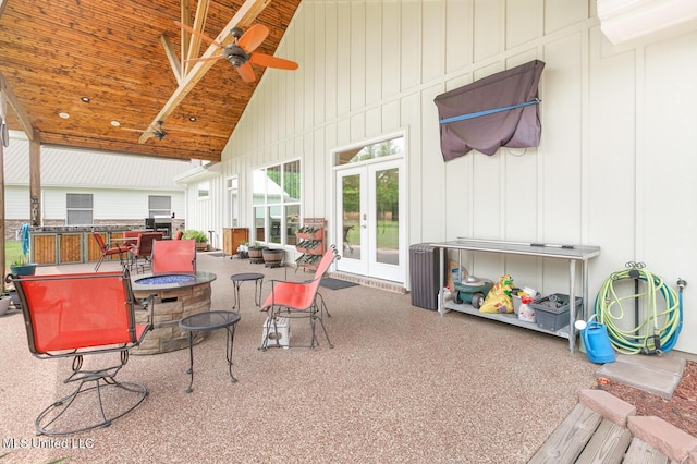 view of patio / terrace with ceiling fan, an outdoor fire pit, and french doors