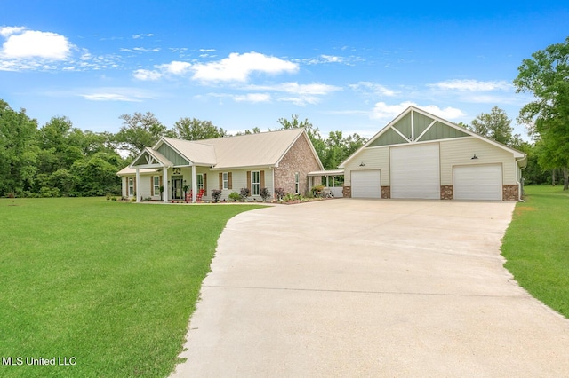 view of front of home featuring a porch, a front lawn, an outbuilding, and a garage