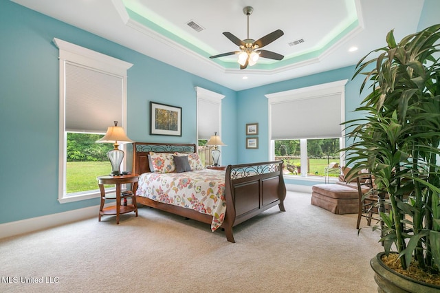 carpeted bedroom featuring ceiling fan, a tray ceiling, visible vents, and recessed lighting