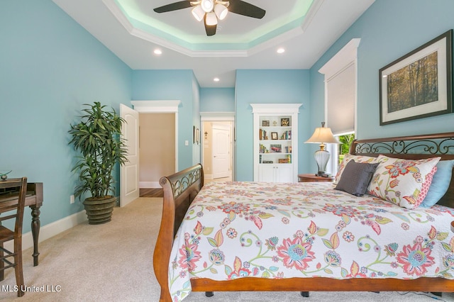 carpeted bedroom with ceiling fan, baseboards, recessed lighting, and a raised ceiling