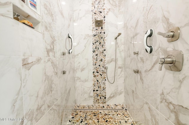 full bath with a tile shower