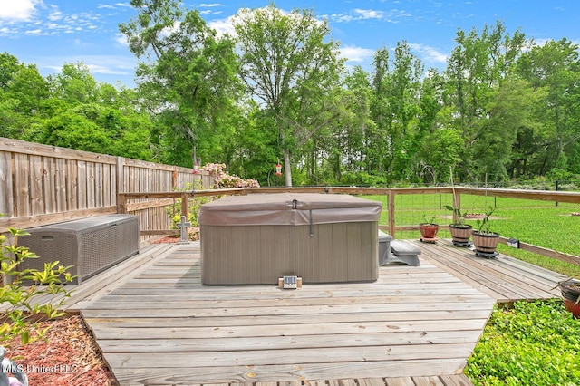 deck featuring fence and a hot tub