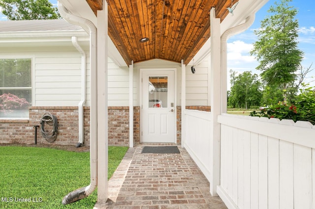 property entrance featuring brick siding