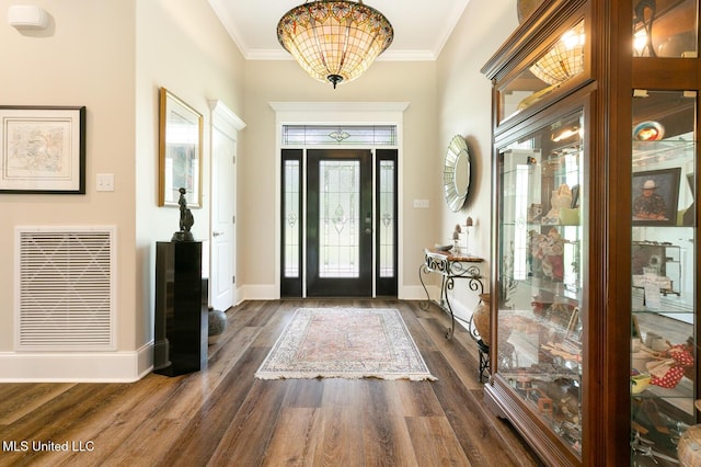 entrance foyer featuring crown molding, baseboards, visible vents, and dark wood-style flooring