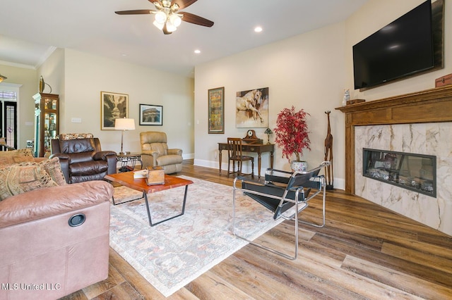 living room with recessed lighting, wood finished floors, a fireplace, and a ceiling fan