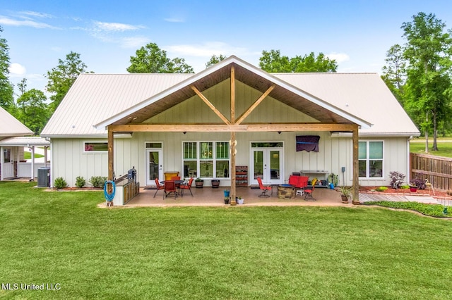 back of property featuring central AC, board and batten siding, french doors, a yard, and a patio