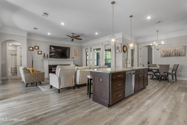 5705 Via Toscana, Ocean Springs, MS 39564 - kitchen with stainless steel dishwasher, a sink, ceiling fan, dark brown cabinetry, and arched walkways