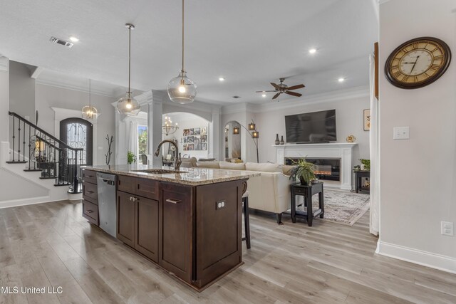 5705 Via Toscana, Ocean Springs, MS 39564 - kitchen featuring a sink, dishwasher, arched walkways, dark brown cabinets, and crown molding