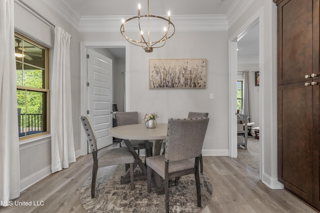 5705 Via Toscana, Ocean Springs, MS 39564 - dining area with ornamental molding, light wood-style flooring, a chandelier, and baseboards
