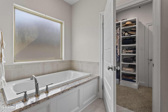5705 Via Toscana, Ocean Springs, MS 39564 - bathroom featuring a walk in closet and a garden tub