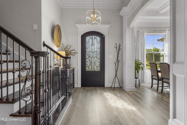 5705 Via Toscana, Ocean Springs, MS 39564 - foyer with plenty of natural light, wood finished floors, arched walkways, and crown molding