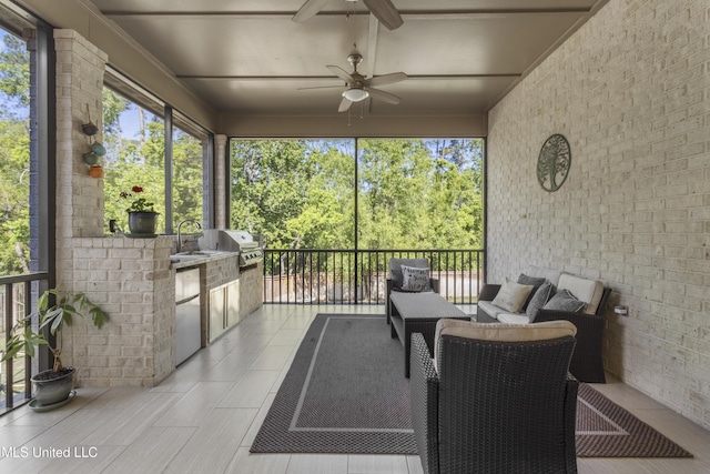 5705 Via Toscana, Ocean Springs, MS 39564 - sunroom / solarium featuring a ceiling fan, an outdoor kitchen, an outdoor living space, and a sink