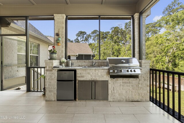 5705 Via Toscana, Ocean Springs, MS 39564 - view of patio featuring a sink, area for grilling, and exterior kitchen