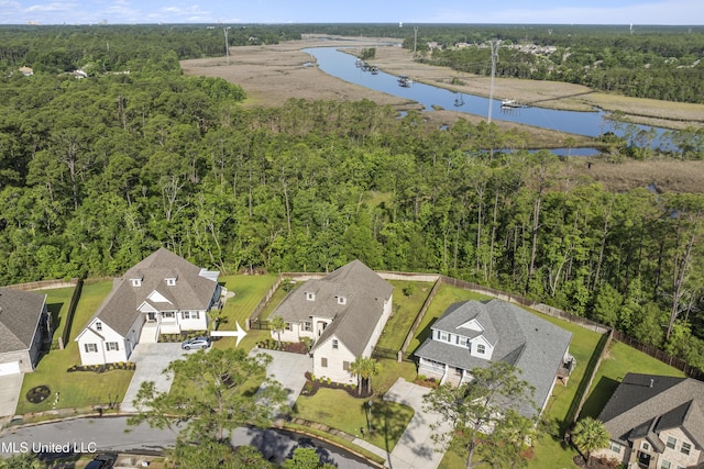 5705 Via Toscana, Ocean Springs, MS 39564 - aerial perspective of suburban area featuring a heavily wooded area and a large body of water