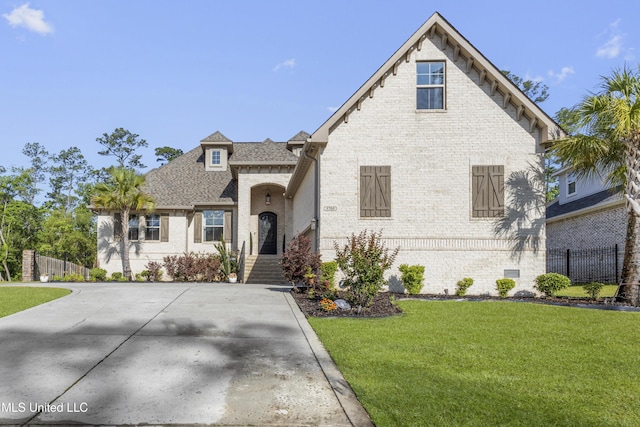 5705 Via Toscana, Ocean Springs, MS 39564 - french country inspired facade with brick siding and roof with shingles