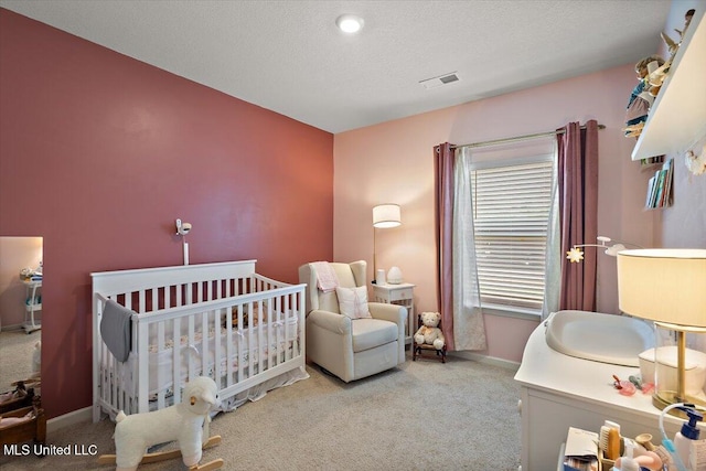 2250 Hyacinth Ln, Hernando, MS 38632 - bedroom with carpet, a crib, and a textured ceiling