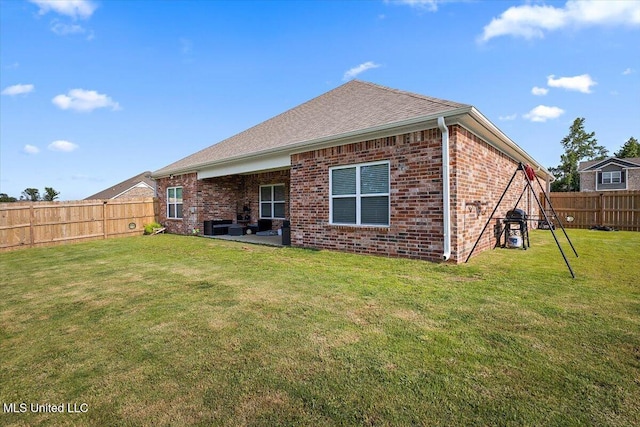 2250 Hyacinth Ln, Hernando, MS 38632 - back of house featuring a fenced backyard, brick siding, a patio, and roof with shingles