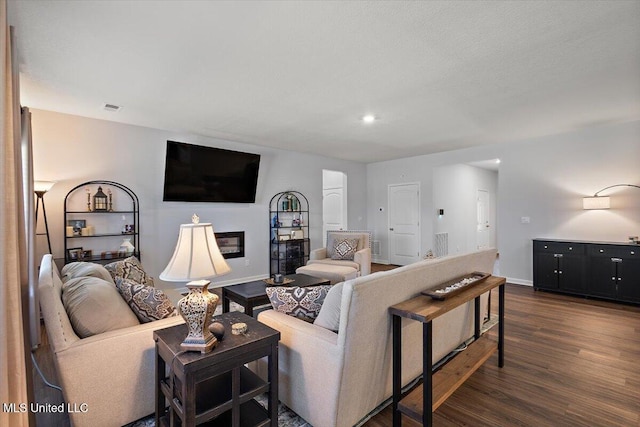 2250 Hyacinth Ln, Hernando, MS 38632 - living area featuring dark wood-style floors, recessed lighting, and a glass covered fireplace
