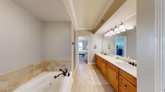 bathroom with vanity, tiled bath, and tile patterned floors