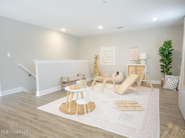 playroom with recessed lighting, wood finished floors, visible vents, and baseboards