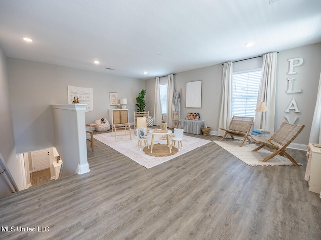 unfurnished living room with recessed lighting, baseboards, and light wood finished floors