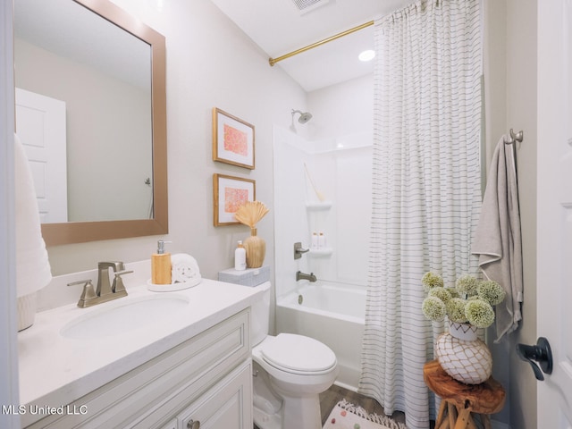 full bath featuring visible vents, shower / bath combo, vanity, and toilet