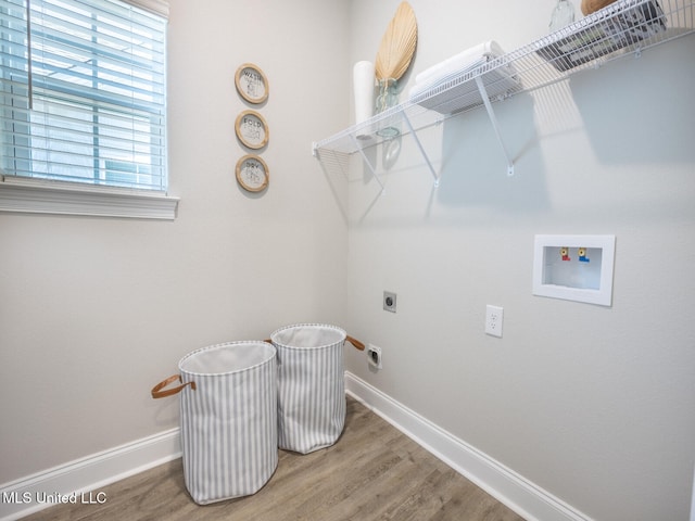 laundry area featuring washer hookup, electric dryer hookup, wood finished floors, laundry area, and baseboards