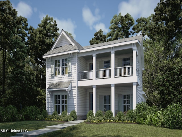 view of front of property featuring a balcony and a front lawn