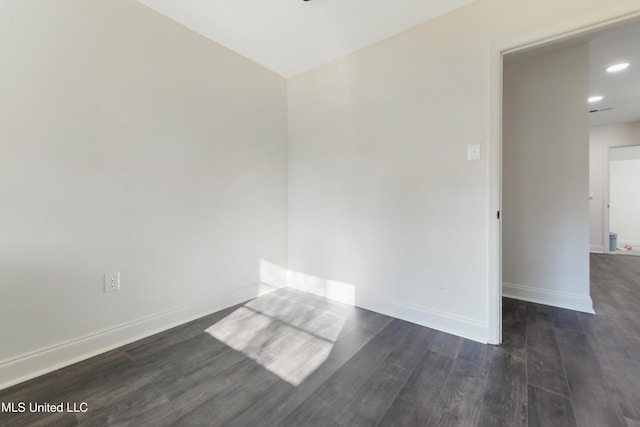 spare room featuring dark wood-type flooring