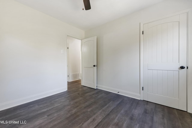 unfurnished bedroom with dark hardwood / wood-style floors and ceiling fan