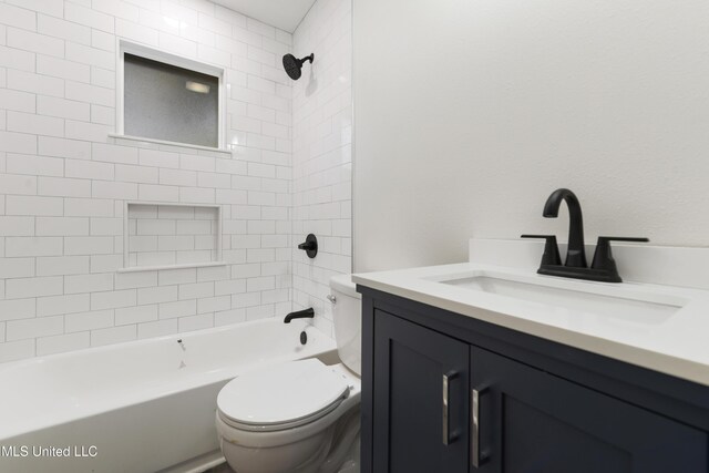 full bathroom with tiled shower / bath, vanity, and toilet